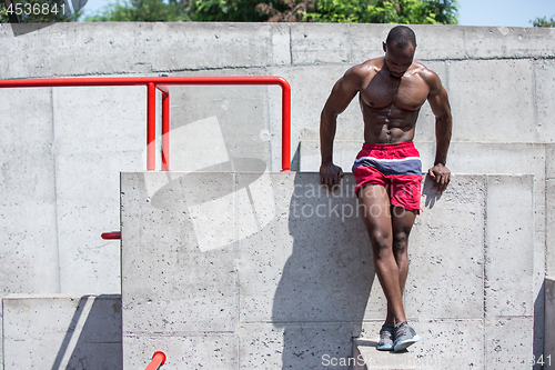 Image of Athlete doing exercises at stadium