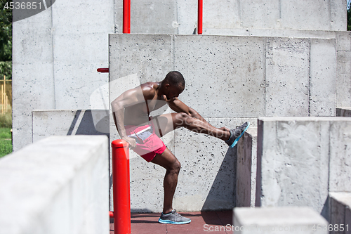 Image of Athlete doing exercises at stadium