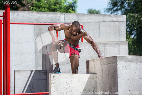 Image of Athlete doing exercises at stadium