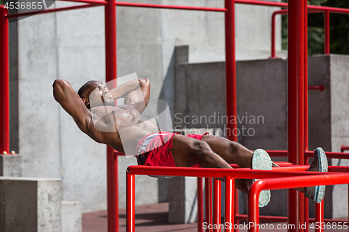 Image of Athlete doing exercises at stadium