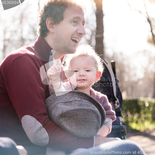 Image of Father with cheerful child in the park.