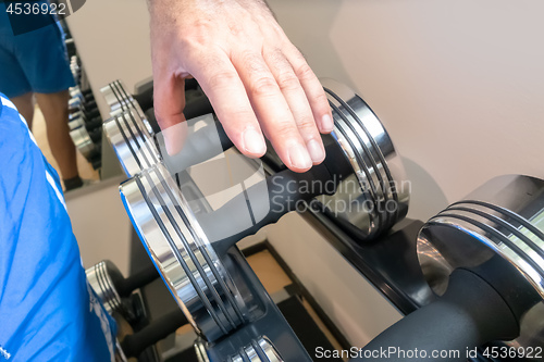 Image of grabbing a dumbbell