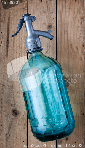 Image of vintage turquoise soda glass bottle