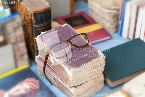 Image of reading glasses on some old books
