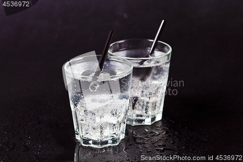 Image of Two glasses of fresh cold carbonated water with ice cubes.