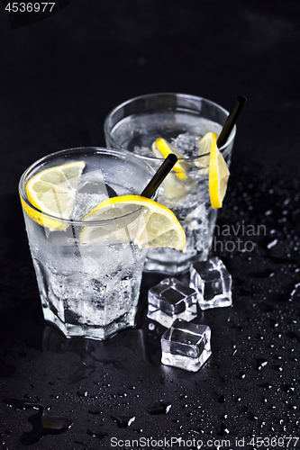 Image of Glasses with fresh cold carbonated water with ice cubes and lemo