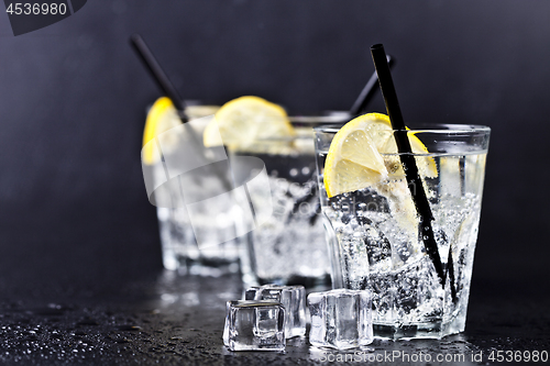 Image of Three glasses with fresh cold carbonated water with lemon slices