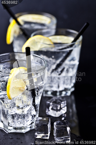 Image of Three glasses with fresh cold carbonated water with lemon slices