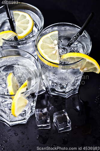 Image of Three glasses with fresh cold carbonated water with lemon slices