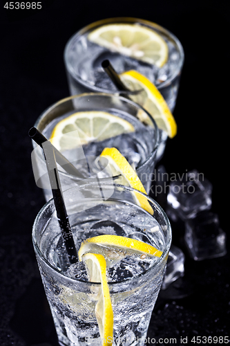 Image of Three glasses with fresh cold carbonated water with lemon slices