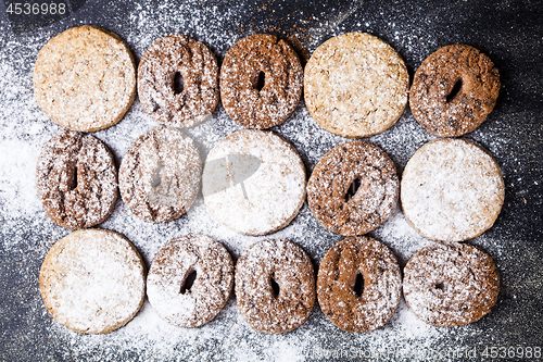 Image of Chocolate chip and oat fresh cookies with sugar powder closeup o