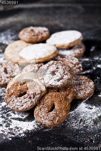 Image of Chocolate chip and oat fresh cookies with sugar powder heap.