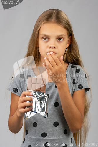 Image of The teen girl got chocolate teeth