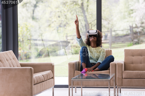 Image of black woman using VR headset glasses of virtual reality