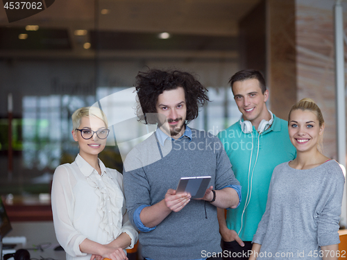 Image of group of Business People Working With Tablet in startup office