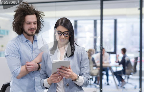 Image of Business People Working With Tablet in startup office