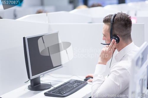 Image of male call centre operator doing his job