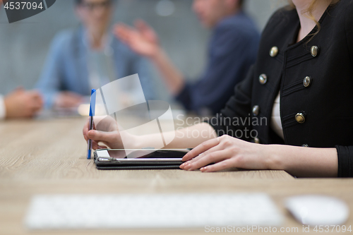 Image of businesswoman hand using pen