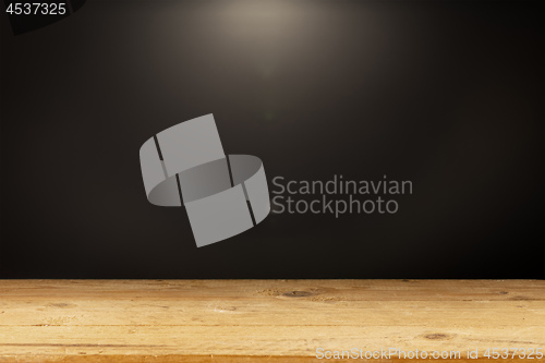 Image of black background light wooden table