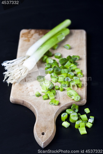 Image of Fresh green organic chopped onions on a cutting board.