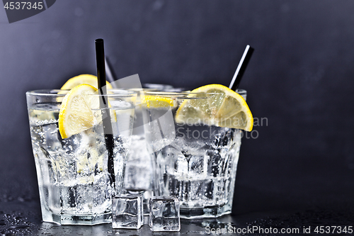 Image of Three glasses with fresh cold carbonated water with lemon slices