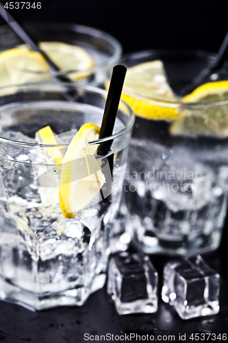 Image of Three glasses with fresh cold carbonated water with lemon slices