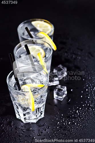 Image of Three glasses with fresh cold carbonated water with lemon slices