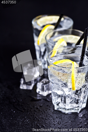 Image of Three glasses with fresh cold carbonated water with lemon slices