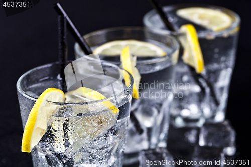 Image of Three glasses with fresh cold carbonated water with lemon slices