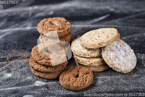 Image of Chocolate chip and oat fresh cookies with sugar powder stacks 