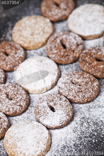 Image of Chocolate chip and oat fresh cookies with sugar powder closeup.