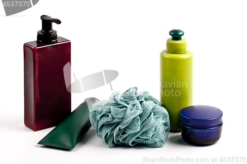 Image of Bath cosmetic products and sponge on white background.