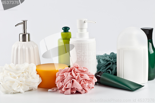 Image of Bath cosmetic products set and sponges on light background. 