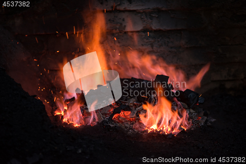 Image of Traditional blacksmith furnace with burning fire