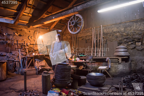 Image of portrait of confident senior blacksmith