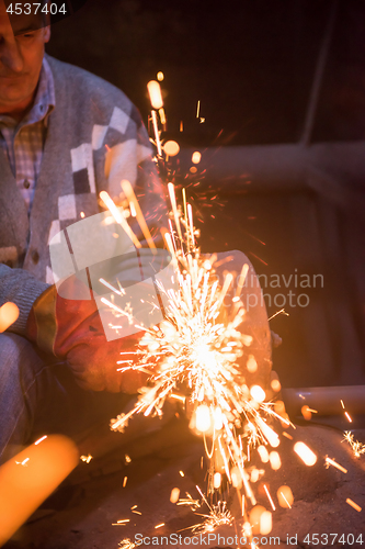 Image of the blacksmith polishing metal products