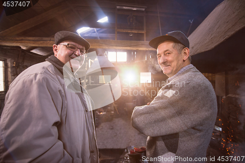 Image of portrait of two confident senior blacksmith