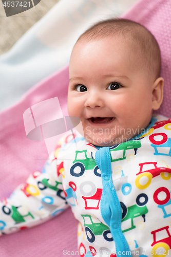 Image of top view of newborn baby boy lying on colorful blankets