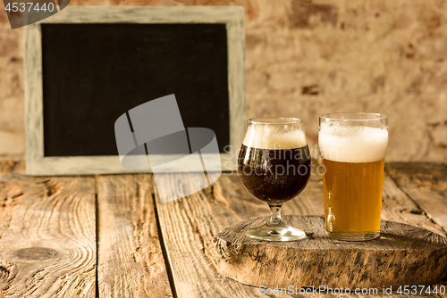 Image of Glasses of different kinds of beer on wooden background