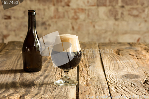 Image of Glasses of different kinds of beer on wooden background