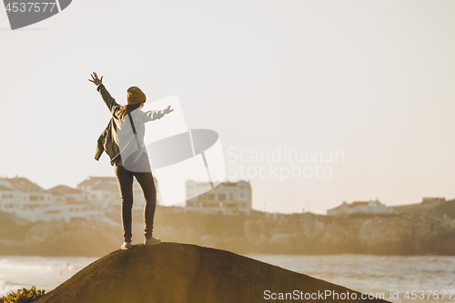 Image of Woman over the cliff