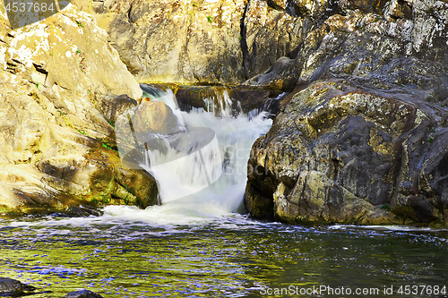 Image of beautiful waterfall over rocks