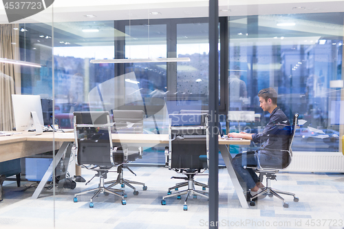 Image of young businessman relaxing at the desk