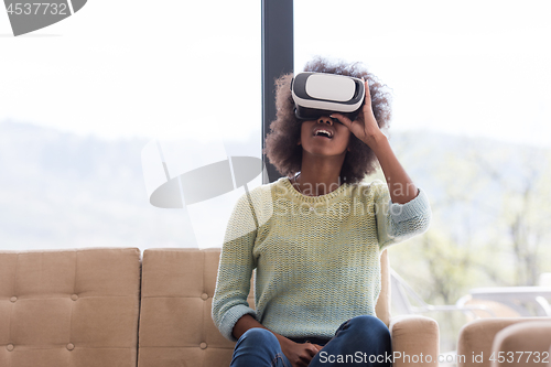 Image of black woman using VR headset glasses of virtual reality