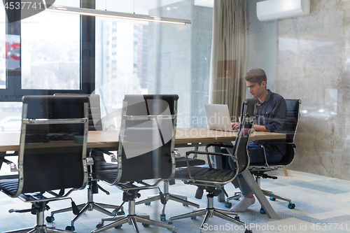 Image of businessman working using a laptop in startup office