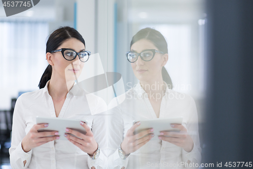 Image of Business Woman Using Digital Tablet in front of startup Office