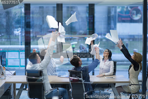 Image of startup Group of young business people throwing documents