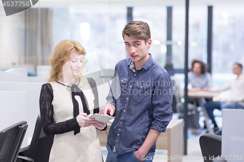 Image of Business People Working With Tablet in startup office
