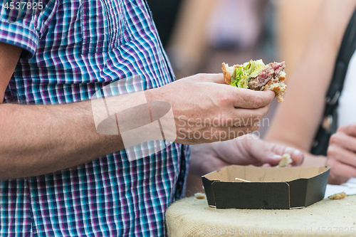 Image of Diet failure of obese man eating fast food unhealthy hamberger.