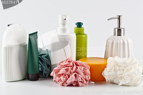 Image of Bath cosmetic products set and sponges on light background. 